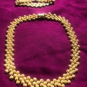 Gold tone fashion necklace and matching bracelet